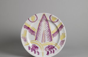 Plate with overglaze painted design of a cat's face and paws